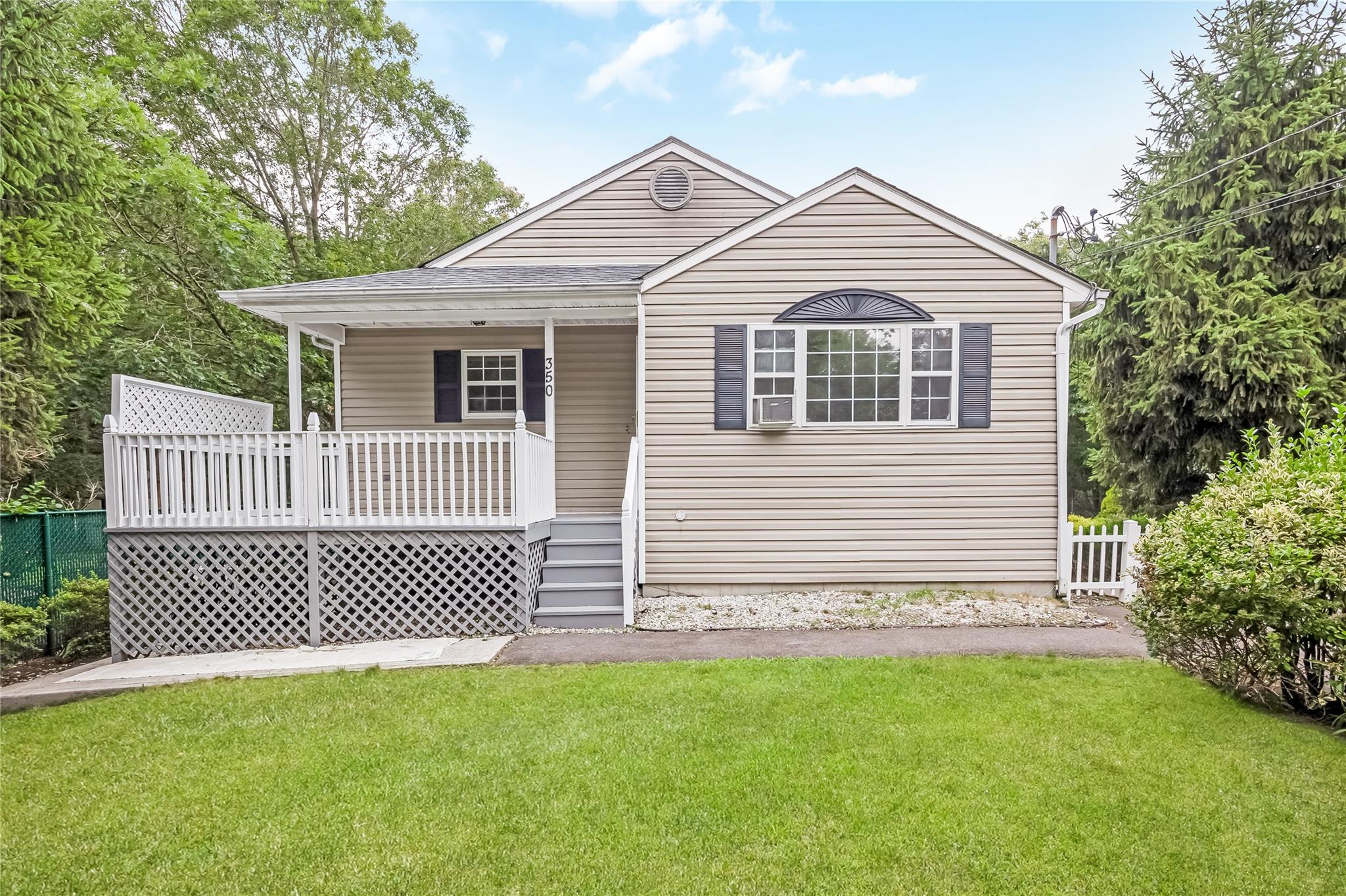 Rear view of property featuring covered porch