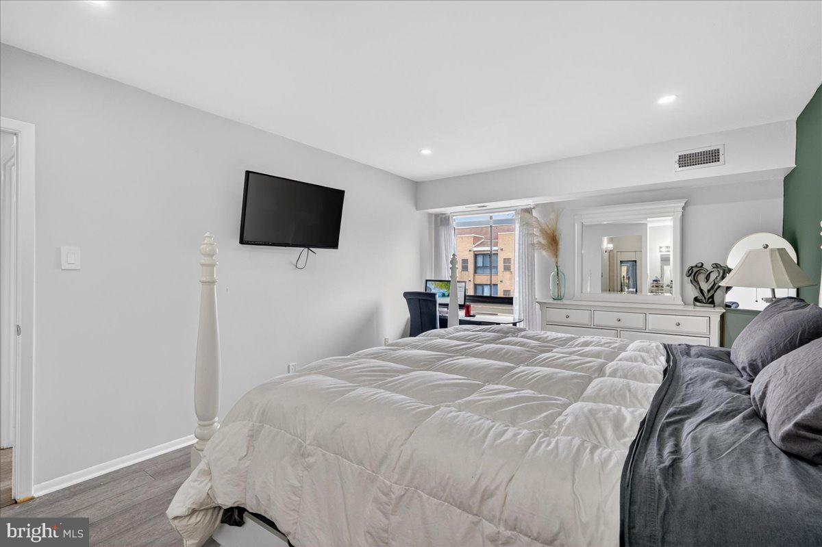 8930 Krewstown Road, Unit 310 Philadelphia, PA 19115 - Photo 17 of 32 a bedroom with a bed and a flat screen tv