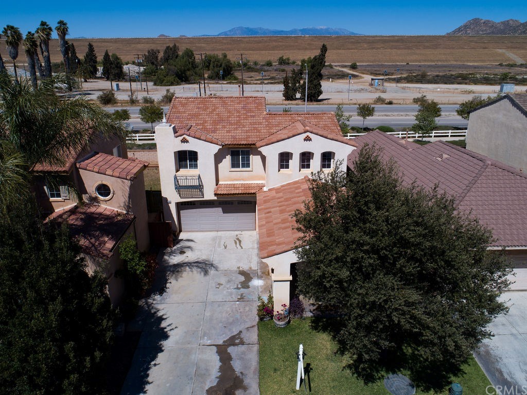 1480 Albillo Loop Perris, CA 92571 - Photo 1 of 1 THE FRONT OF THE HOME WITH THE EXTENDED 4 CAR LONG DRIVE WAY