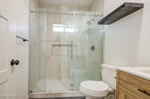 a bathroom with a shower and a toilet