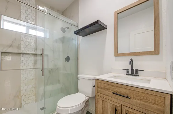 a bathroom with a sink toilet and shower
