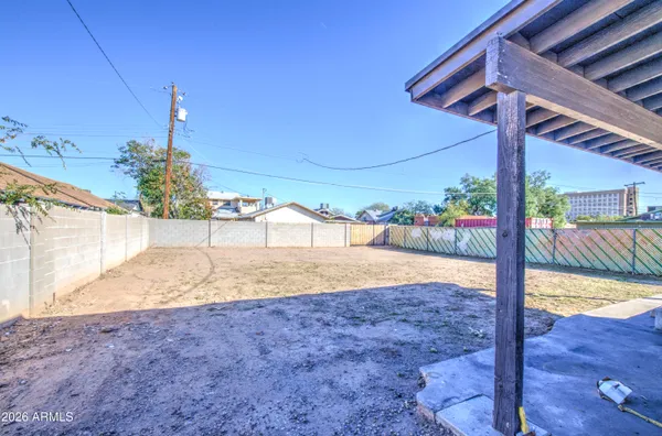 a view of a backyard patio and wooden fence