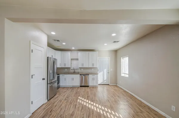 a kitchen with stainless steel appliances a refrigerator sink and cabinets