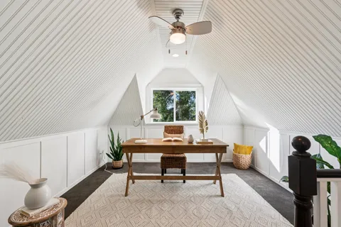 a living room with furniture and a mirror