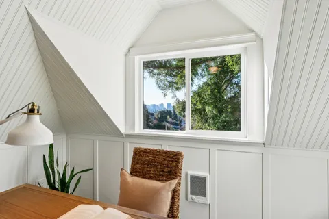 a bedroom with a large bed and a window