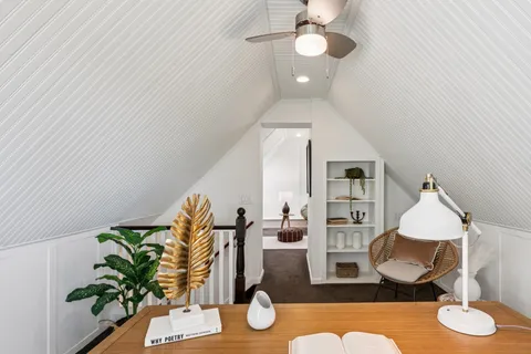 a bedroom with bed and wooden floor