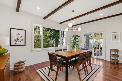 a view of a dining room with furniture window and wooden floor