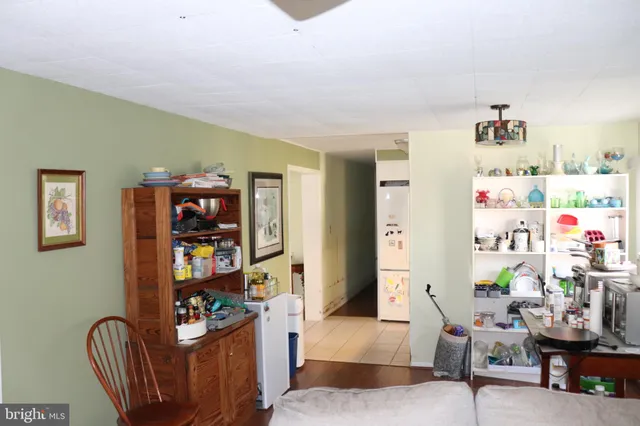 a living room with furniture and a book shelf