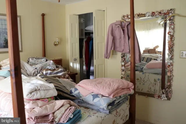 a bedroom with a bed and a mirror