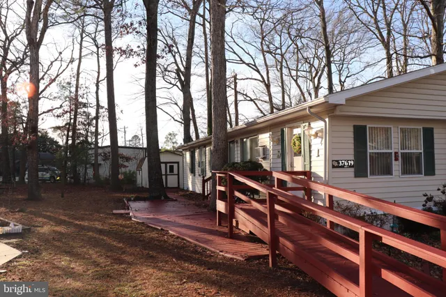 a view of a house with backyard porch and sitting area