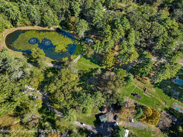 an aerial view of a residential houses with yard and outdoor seating