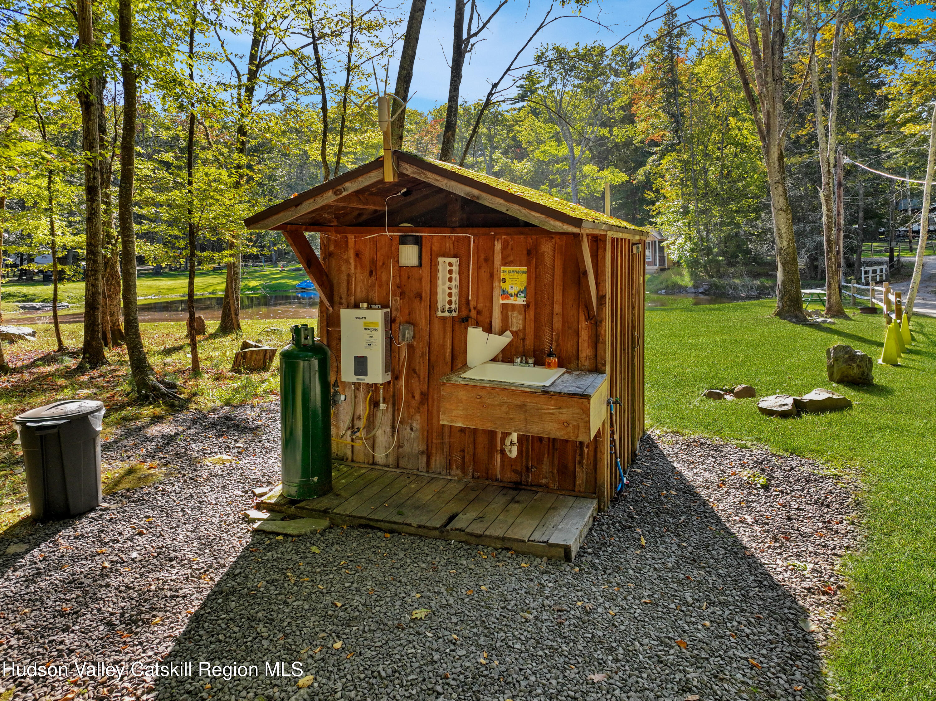 425 Woodland Road Accord, NY 12404 - Photo 24 of 28 a view of a small house with a yard bed and wooden fence