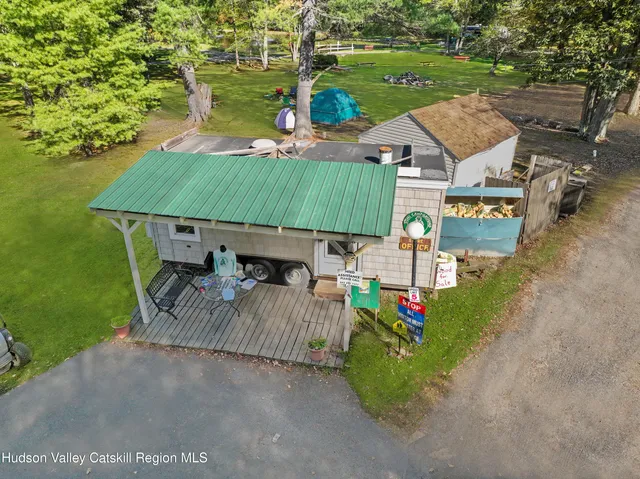 an aerial view of a house with garden space and street view