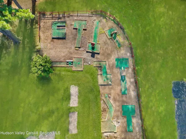 a aerial view of a house with a yard and lake view