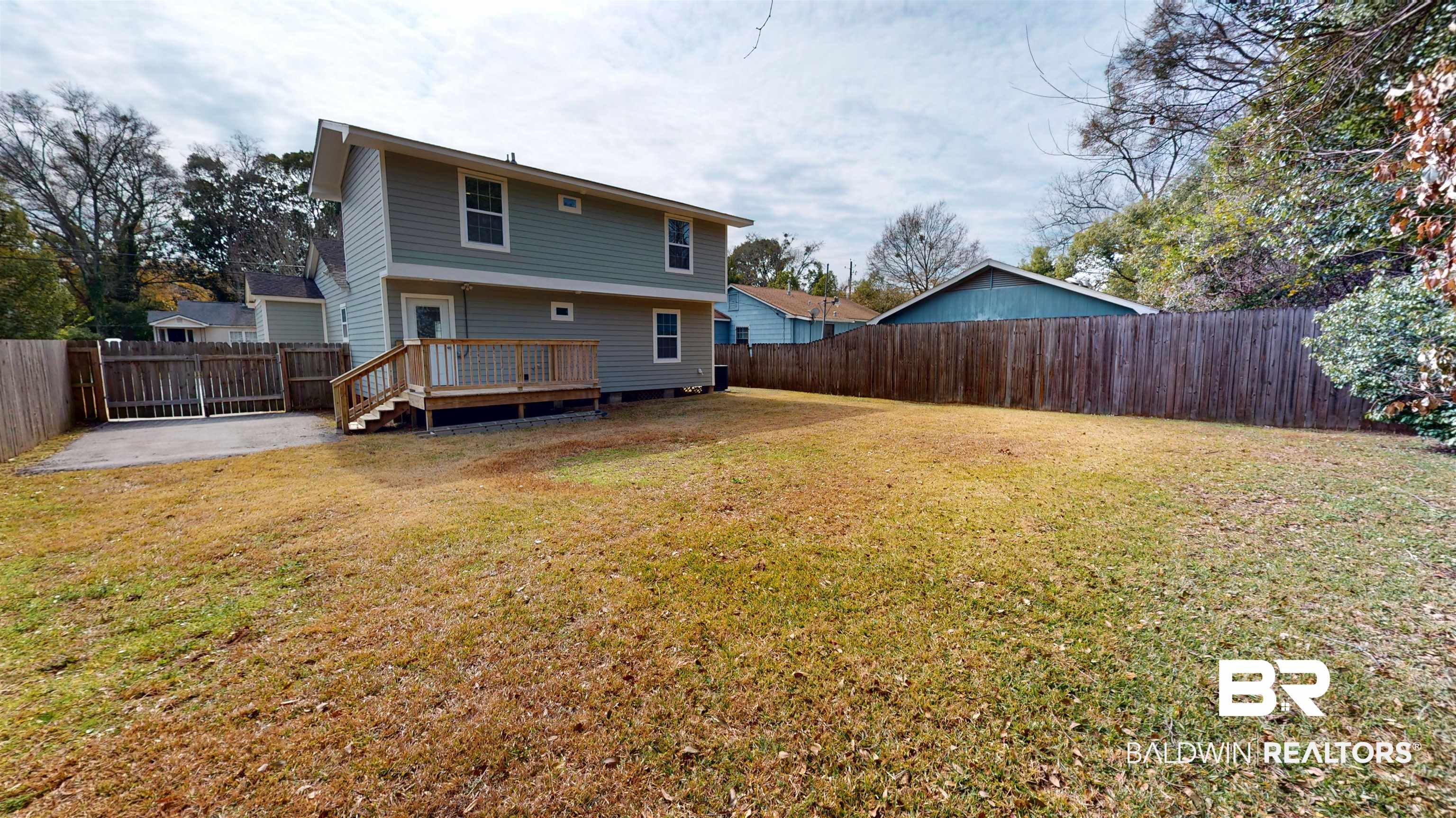 2454 Taylor Avenue Mobile, AL 36606 - Photo 3 of 24 Rear view of house with a fenced backyard and a deck