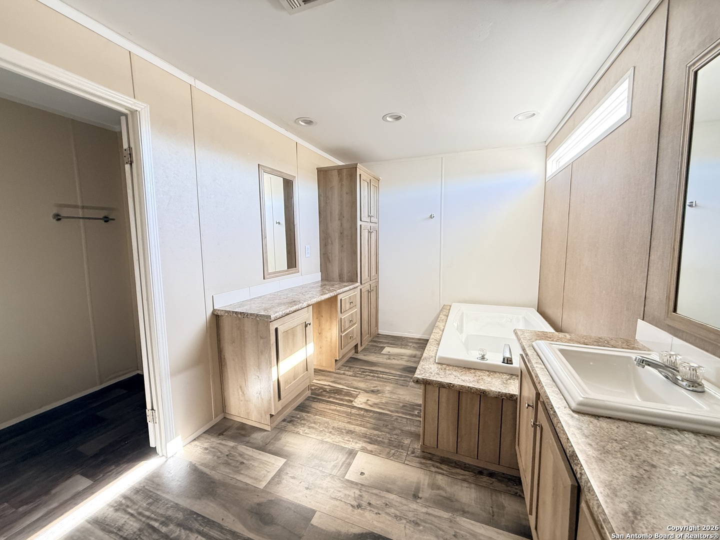 1009 County Road 773 Devine, TX 78016 - Photo 12 of 15 a room with a wooden floor and a sink