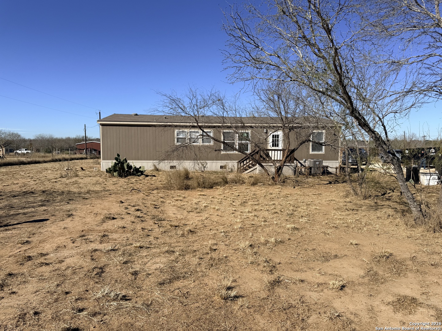 1009 County Road 773 Devine, TX 78016 - Photo 15 of 15 a view of a backyard of the house
