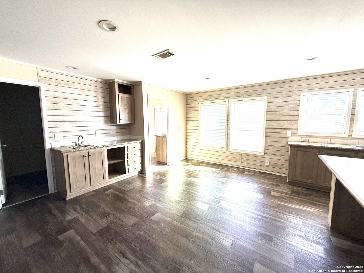 1009 County Road 773 Devine, TX 78016 - Photo 3 of 15 a kitchen with stainless steel appliances granite countertop a stove and a wooden floors
