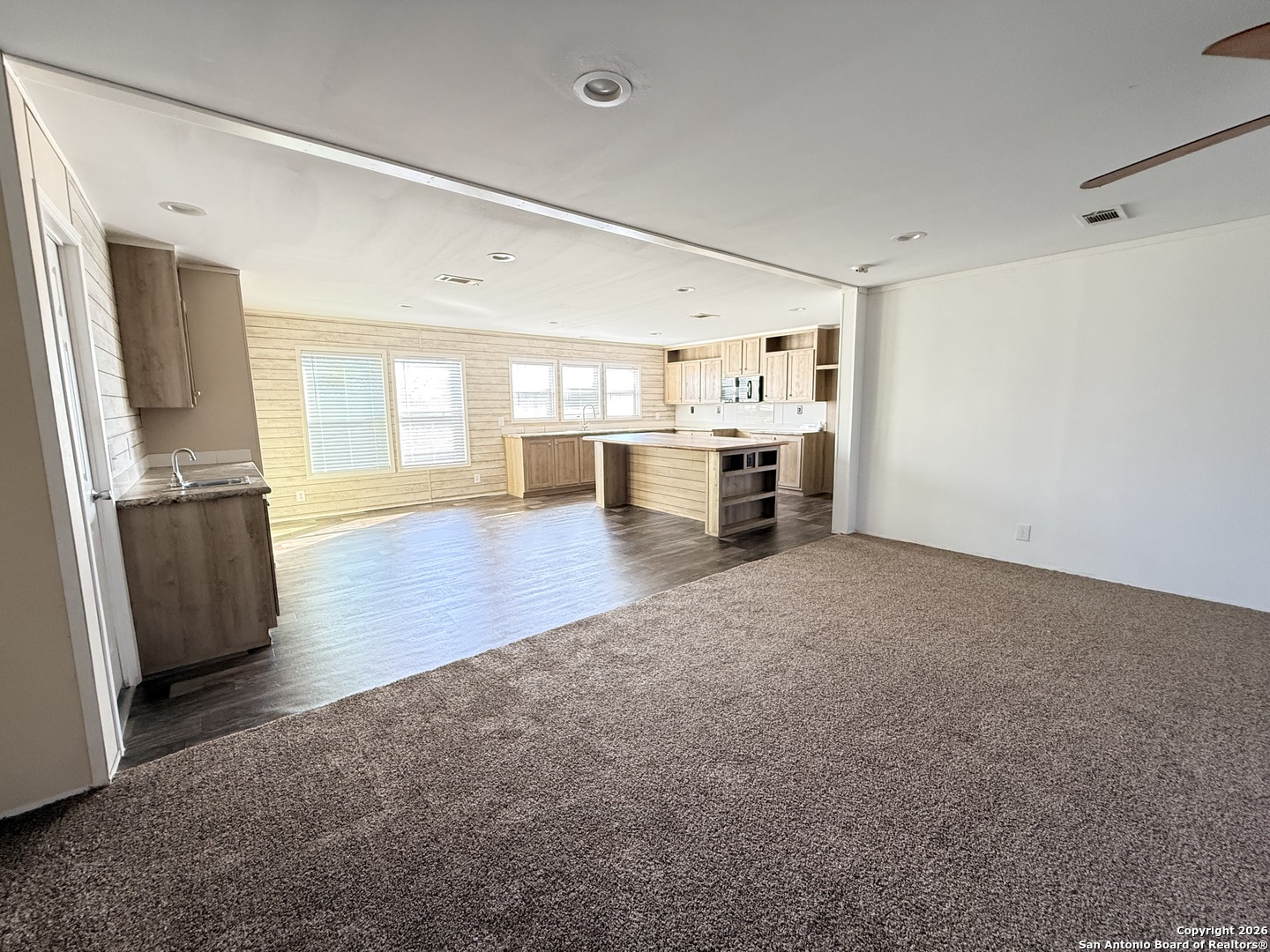 1009 County Road 773 Devine, TX 78016 - Photo 8 of 15 a view of a kitchen with furniture and a window