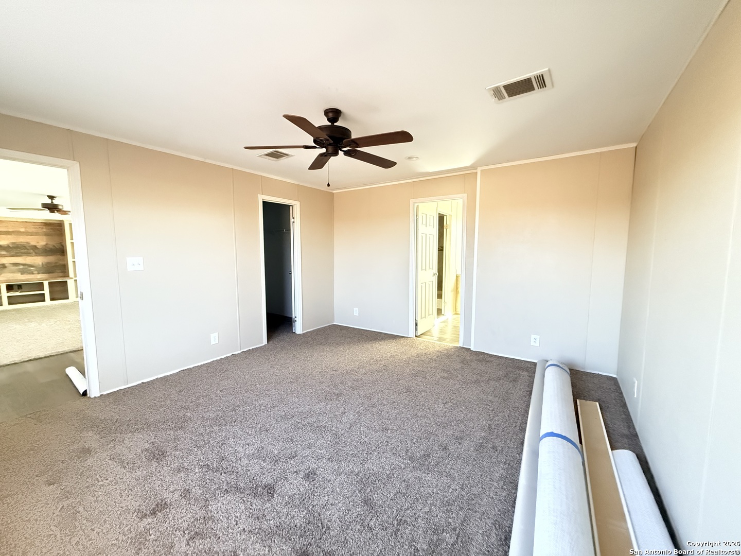 1009 County Road 773 Devine, TX 78016 - Photo 10 of 15 a view of a livingroom with a ceiling fan and window