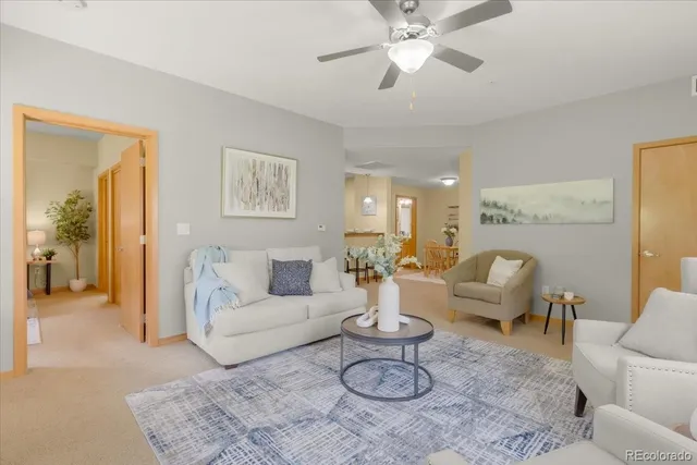 a living room with furniture a rug and a chandelier