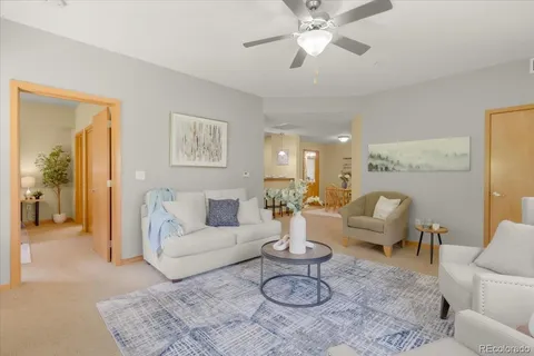 a living room with furniture a rug and a chandelier