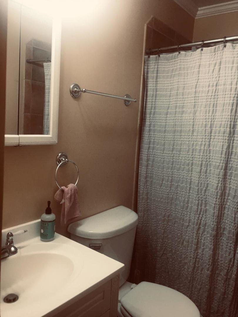 14914 Kedvale Avenue Midlothian, IL 60445 - Photo 10 of 12 a bathroom with a sink a toilet and shower