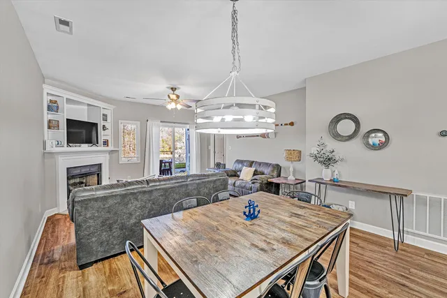 a living room with dining table and chairs