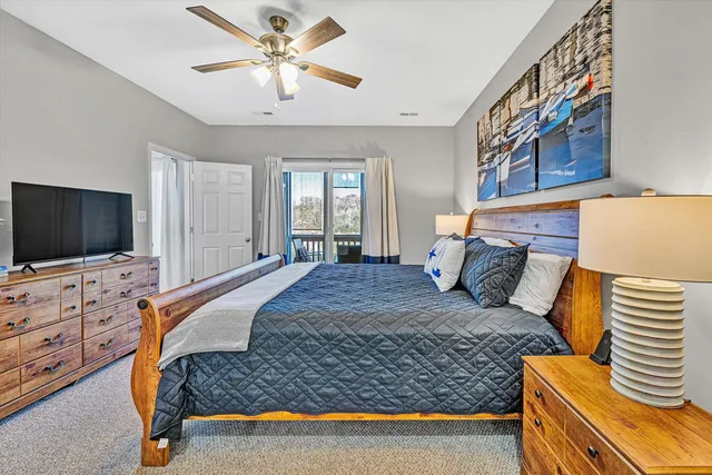 a bedroom with a bed and flat screen tv
