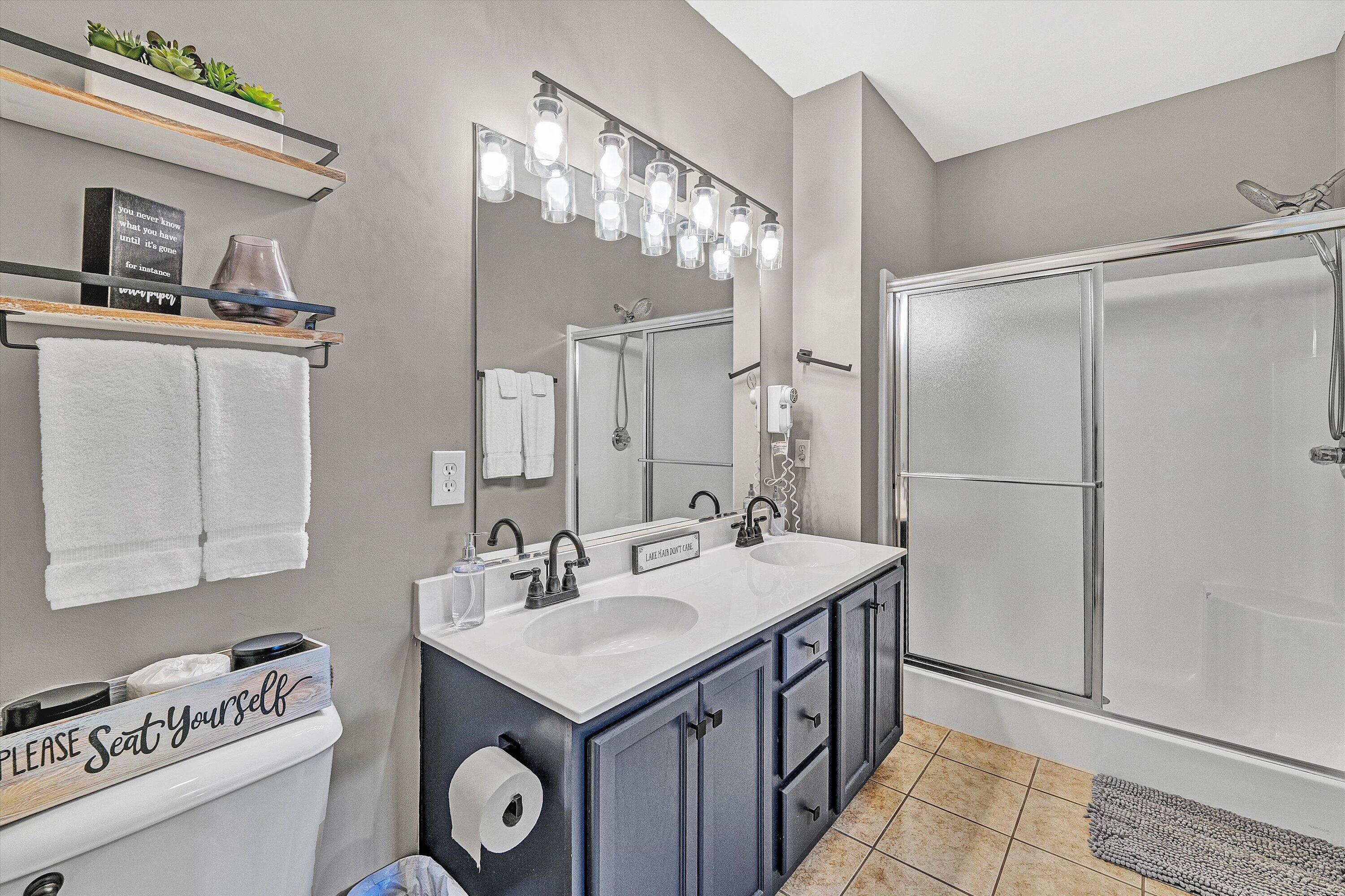 1175 Mariners Way, Unit 59 Huddleston, VA 24104 - Photo 19 of 44 a spacious bathroom with a sink a toilet and a mirror