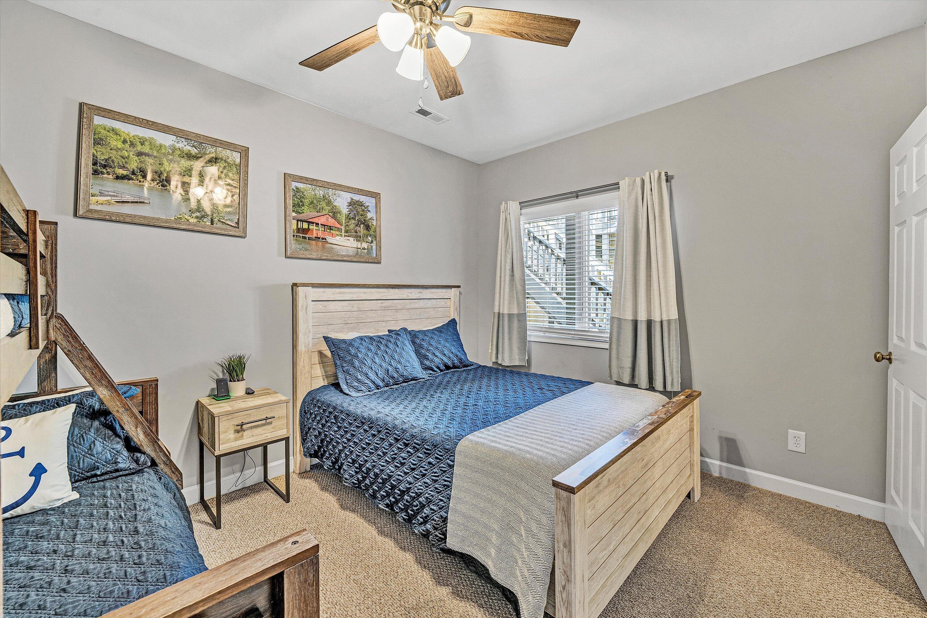 1175 Mariners Way, Unit 59 Huddleston, VA 24104 - Photo 21 of 44 a bedroom with a large bed and a chandelier