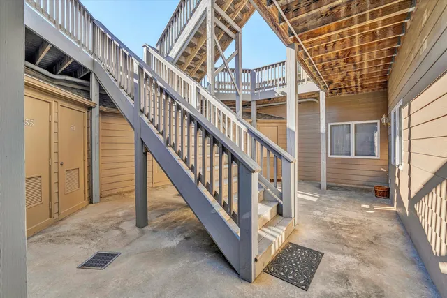 a view of staircase with white walls and a window