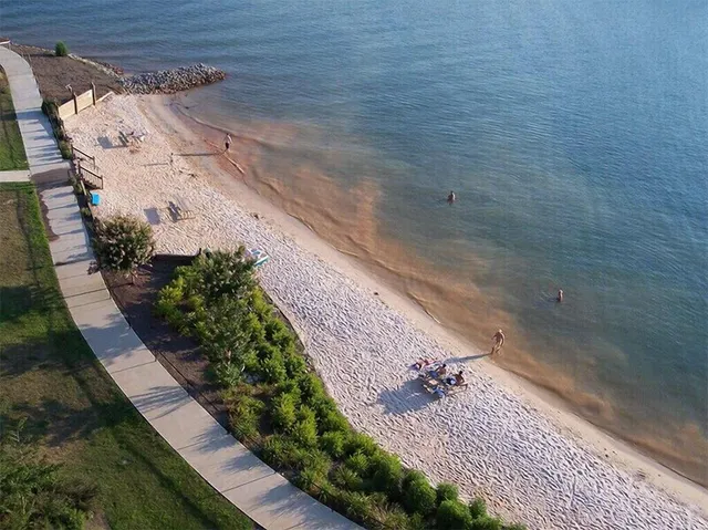 an aerial view of a house with outdoor space swimming pool and lake view