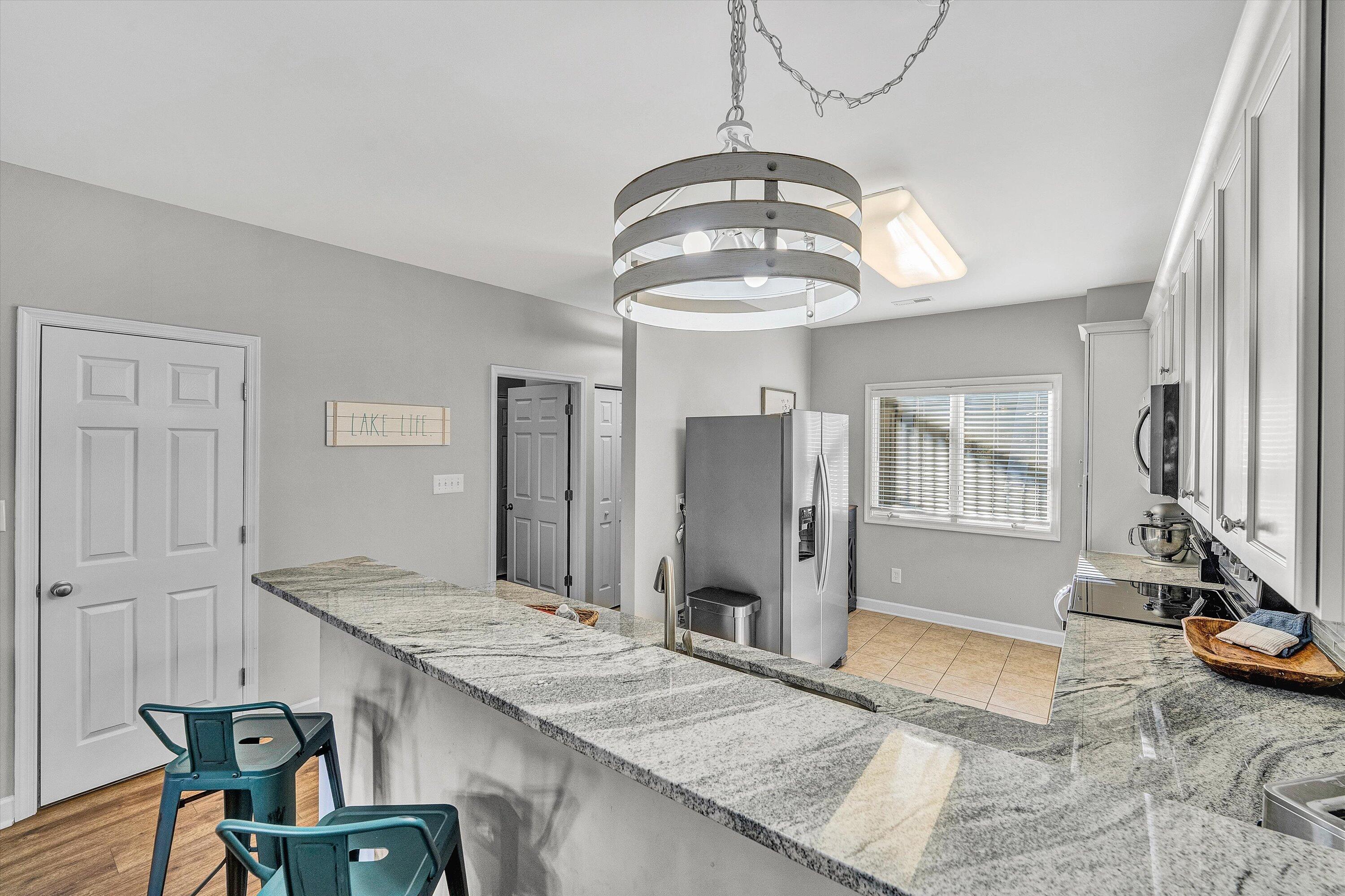1175 Mariners Way, Unit 59 Huddleston, VA 24104 - Photo 5 of 44 a view of a kitchen with granite countertop windows and refrigerator