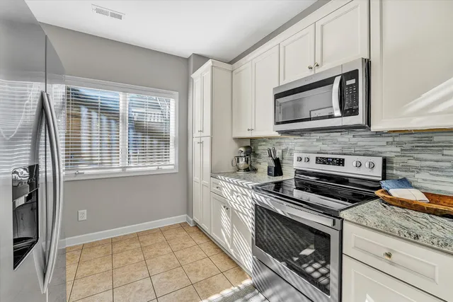 a kitchen with cabinets appliances and a sink