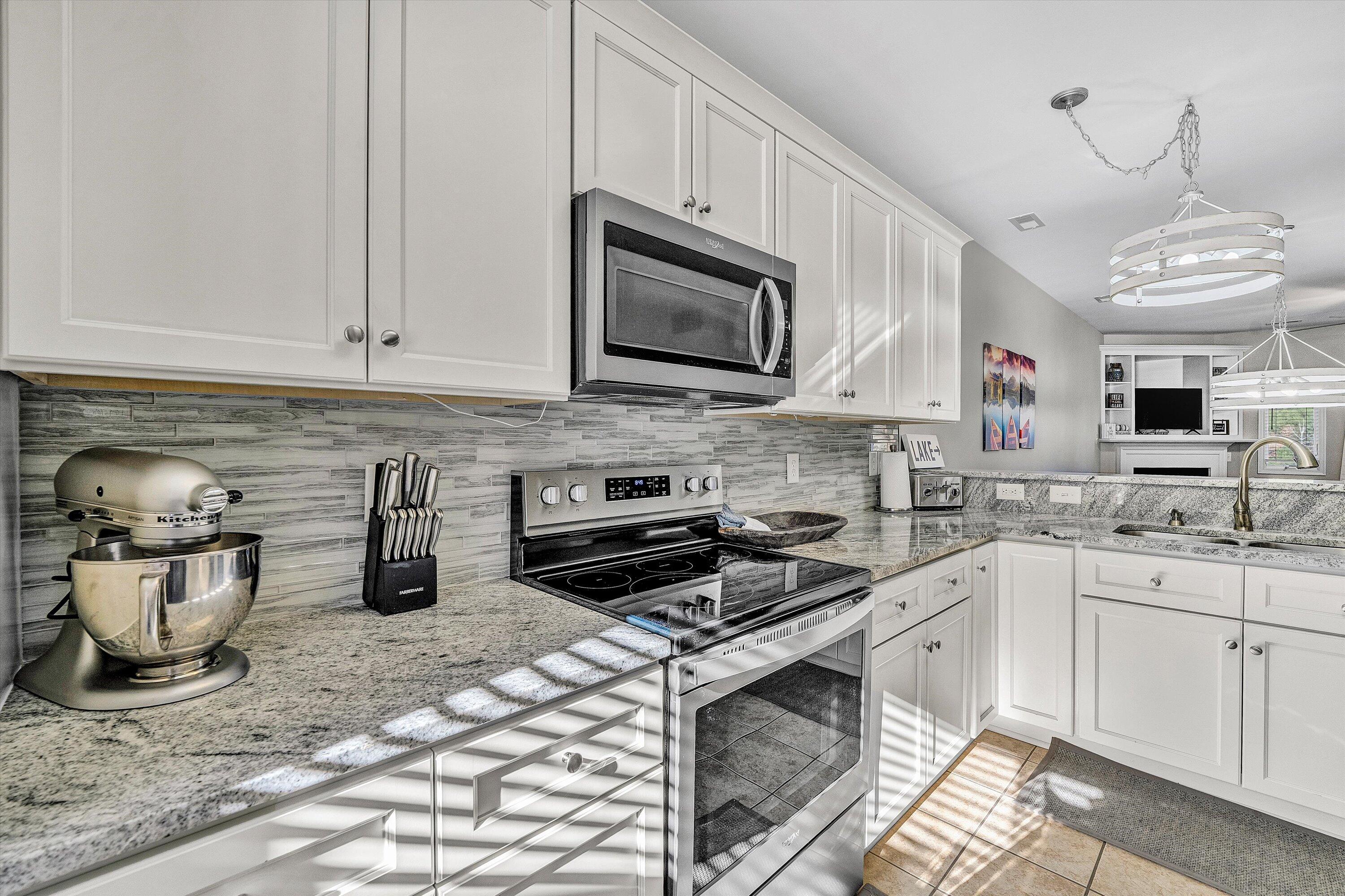 1175 Mariners Way, Unit 59 Huddleston, VA 24104 - Photo 8 of 44 a kitchen with stainless steel appliances granite countertop a sink stove and cabinets