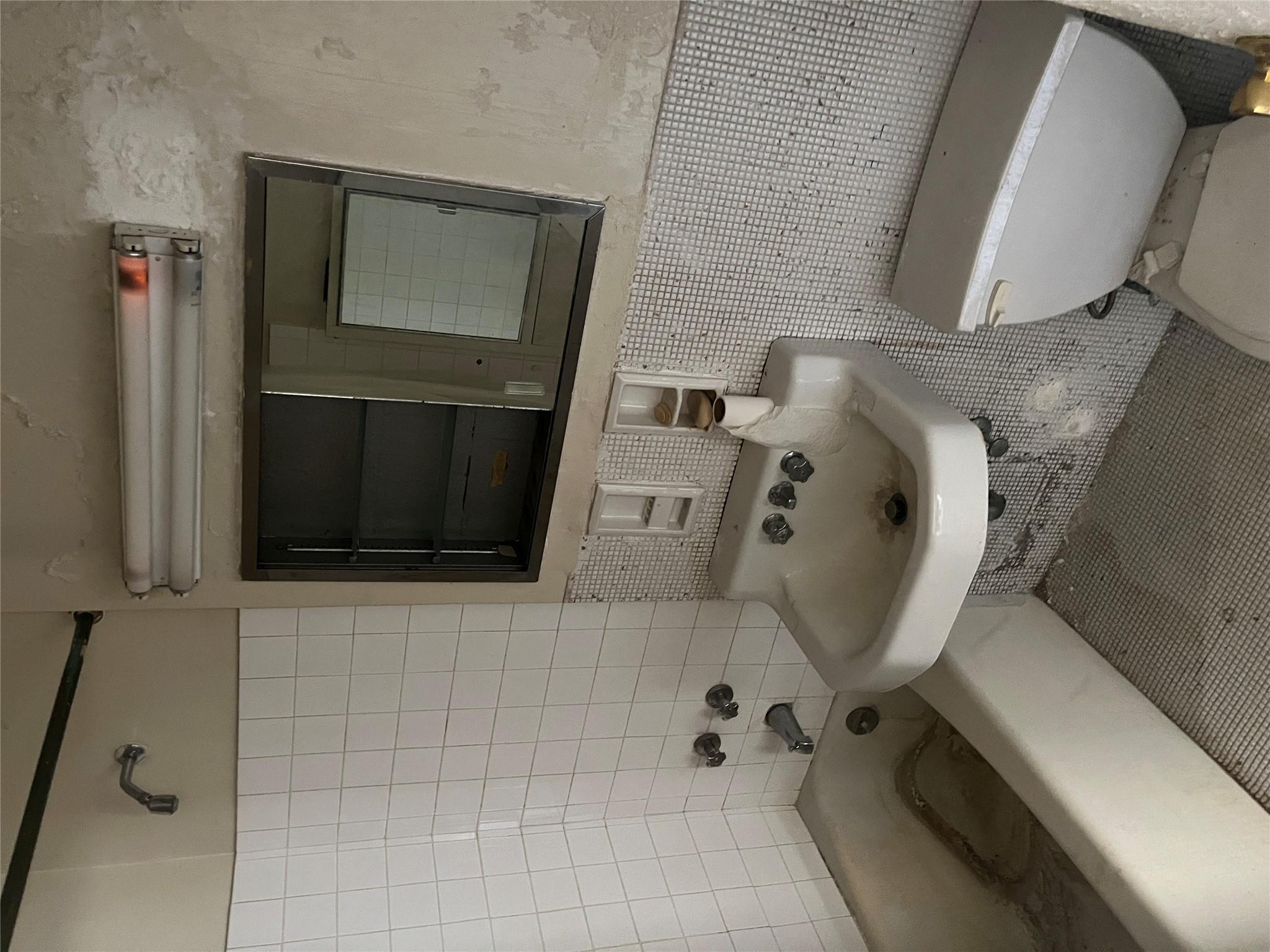 1020 Grand Concourse, Unit 23T Bronx, NY 10451 - Photo 8 of 13 Full bathroom with sink, tub / shower combination, toilet, and tile walls