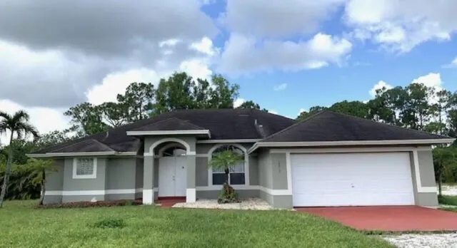 a front view of a house with garden