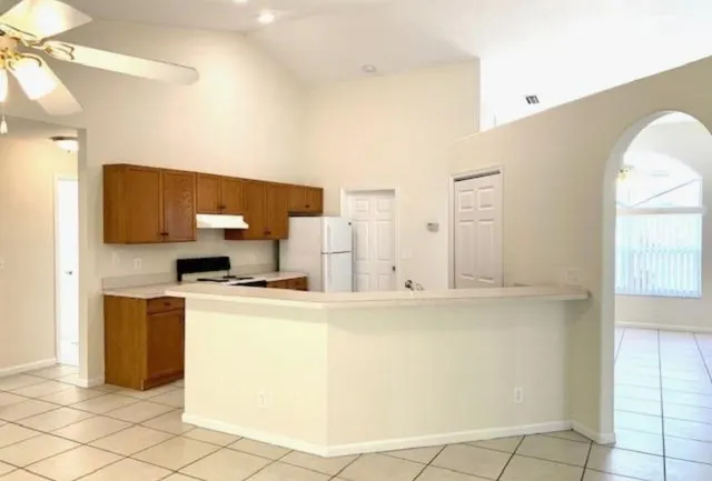 a kitchen with stainless steel appliances cabinets and wooden floor