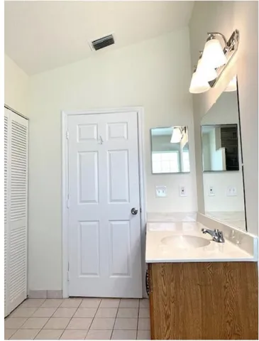 a bathroom with a sink a mirror and a bathtub