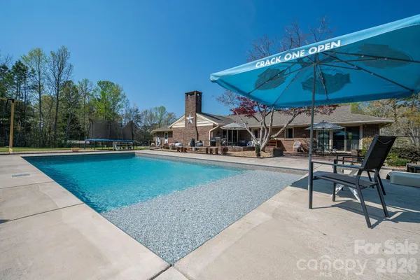 a swimming pool with outdoor seating and yard