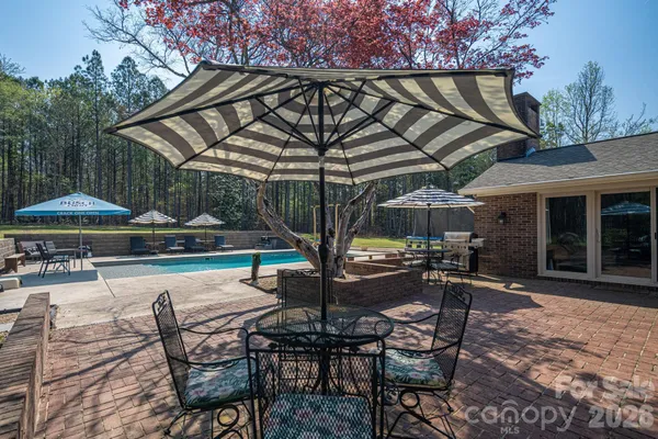 a patio with patio a table and chairs under an umbrella