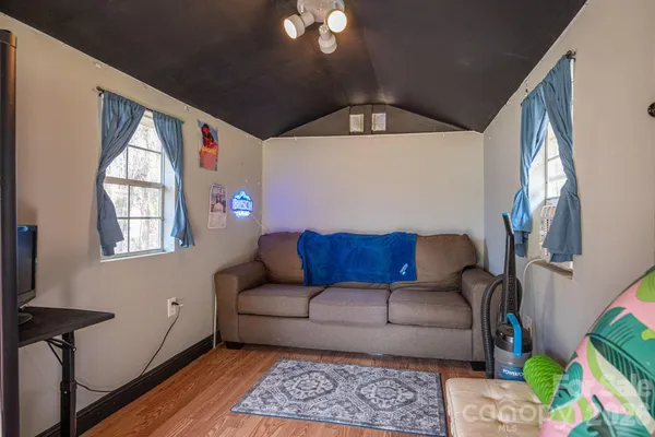 a kitchen with stainless steel appliances granite countertop wooden cabinets a sink and dishwasher a stove top oven with wooden floor