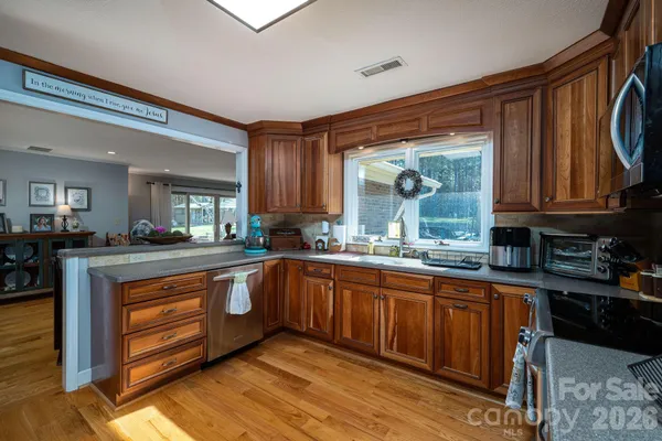 a metallic refrigerator freezer sitting in a kitchen