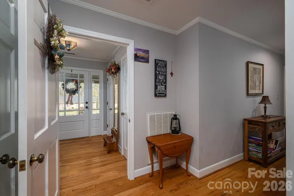 a view of a dining room with furniture a chandelier and wooden floor