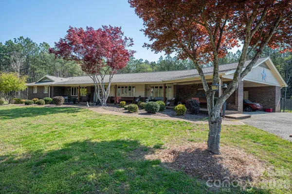 a view of a house with swimming pool and a table and chairs