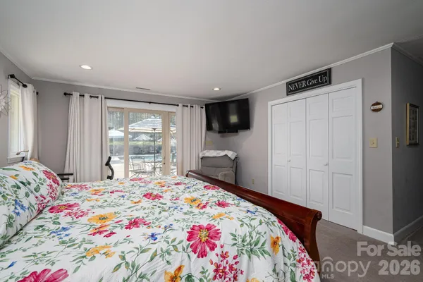 a bathroom with a granite countertop sink a toilet a shower and a mirror