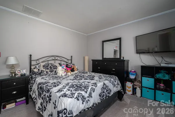 a bedroom with a bed window and a television