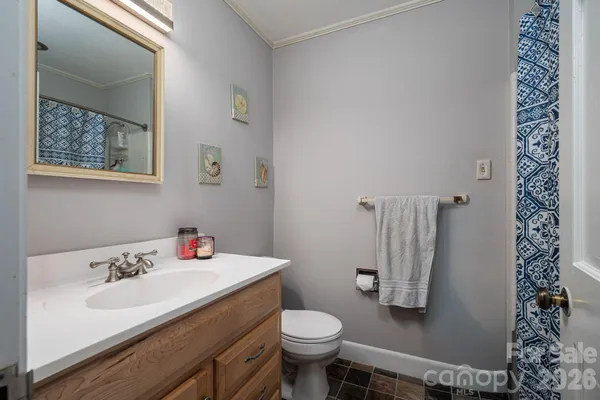 a bedroom with a bed and flat tv screen on the dresser