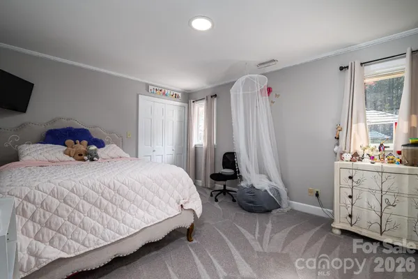 a bedroom with a bed and a book shelf